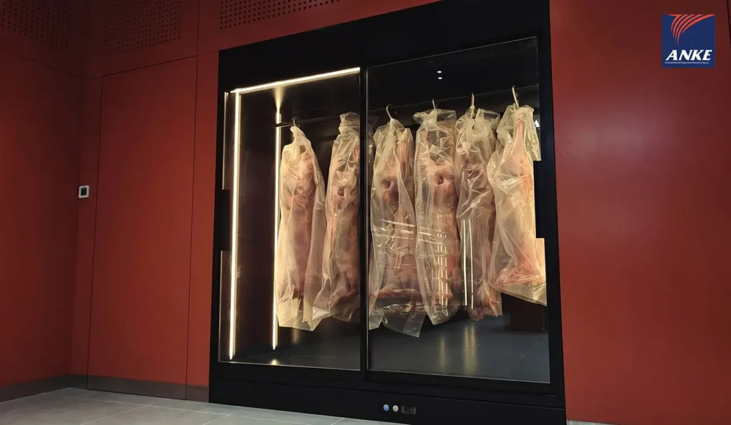 ANKE upright commercial meat display with carcass hanging system stores whole lambs while maintaining 0 to 4°C refrigeration for UAE butcheries